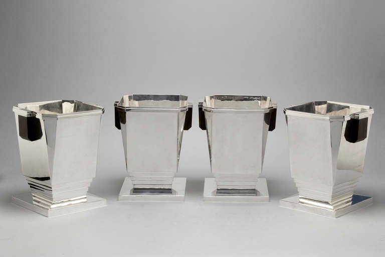 A magnificent set of 4 sterling silver wine coolers with Macassar Ebony handles.  Sterling silver.  London 2013.  Maker JSA.  These are a perfect copy of an original design by Bountaburet Paris circa 1925 and are an iconic Art Deco design.  They are