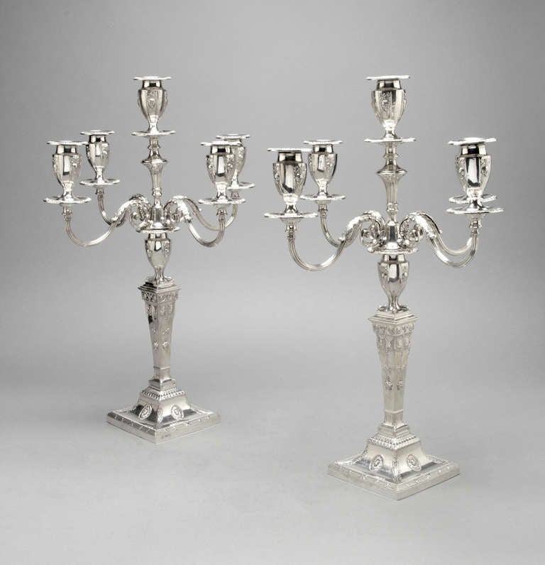 A superb pair of candelabra.  Sterling silver, English 1900.  Maker Hawkseworth Eyres.  These are a fine example in the style of the 18th century. They have 5 candle holders but can also be reduced to a 3 branch for a smaller table.  They are fully