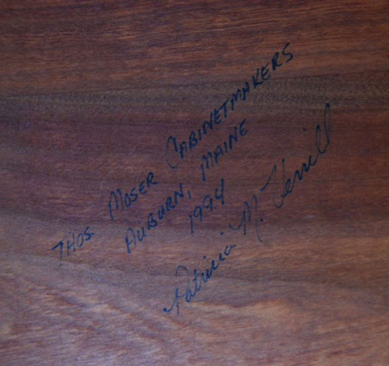 This unique rocking bench was custom-made in 1994 for a private buyer by the Auburn, Maine workshop of Thos. Moser Cabinetmakers. It features the distinctive continuous arm prized in the maker's signature chair. The bench is signed on the underside
