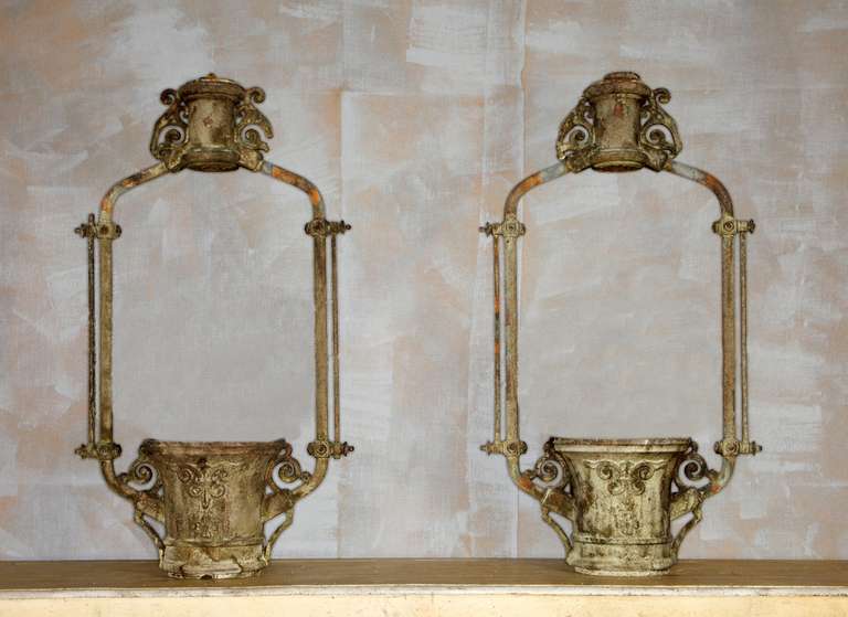 A pair of cast iron planters
Look wonderful suspended, have been used to hold champagne in a bar
