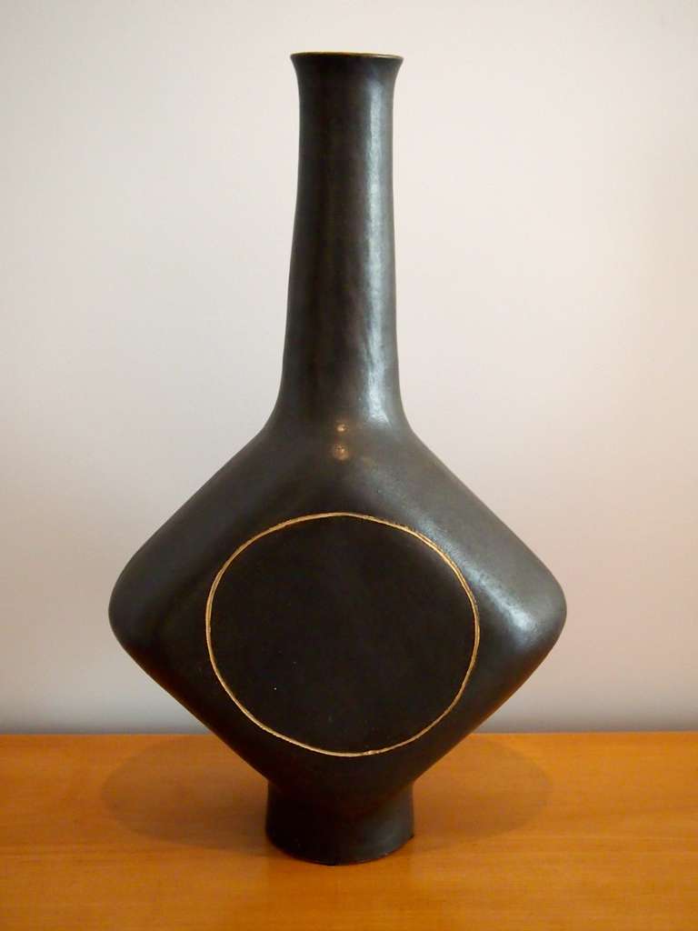 Pair of large sandstone ceramic vases. One black and one off-white enamel. Both vases have an engraved circle on both face sides. Both vases are signed Gambone Italy.