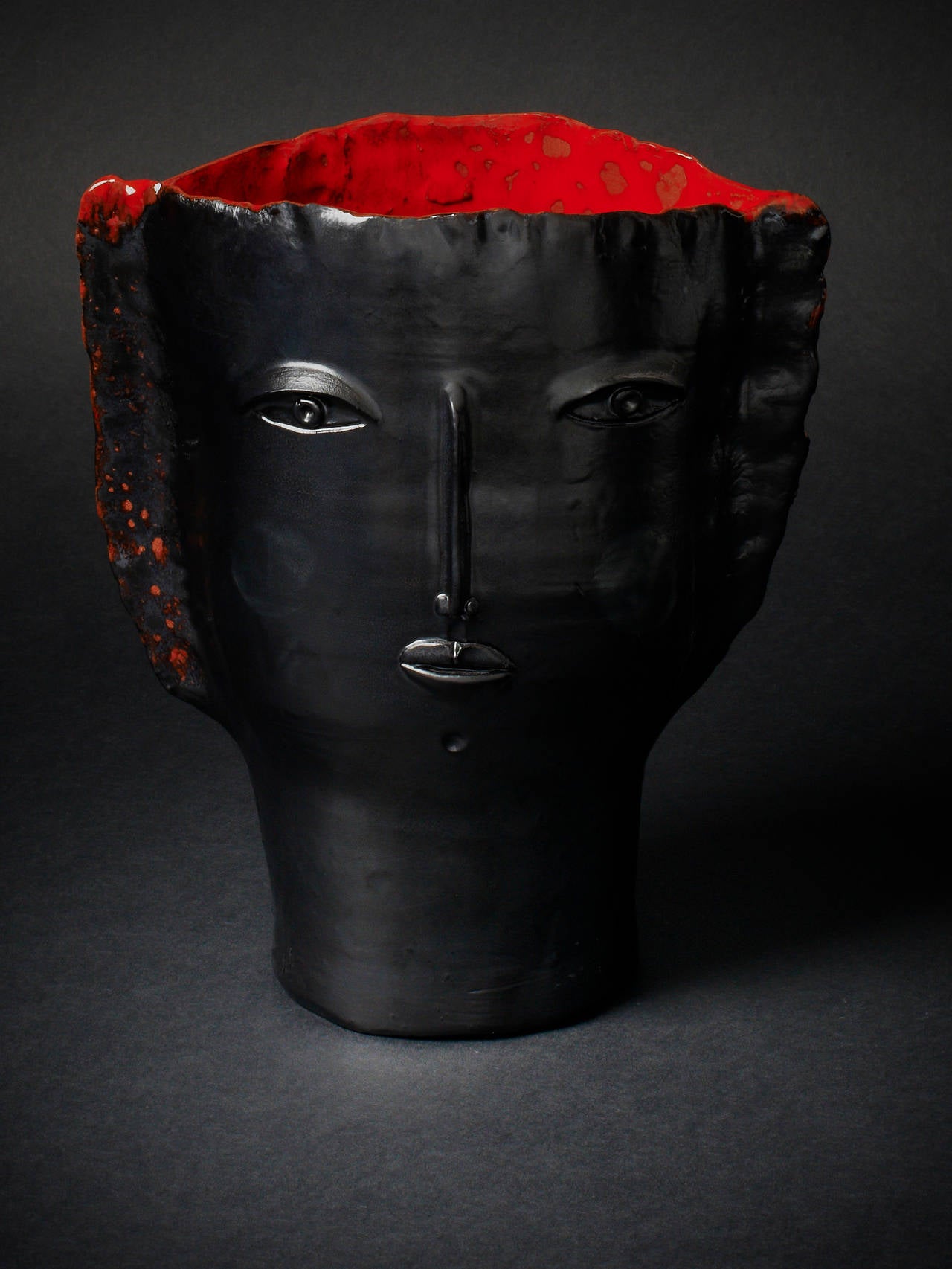 Robert and Jean Cloutier. Ceramic vase 'Visage au chignon'. Black ceramic with red enamel inside. Signed Cloutier RJ