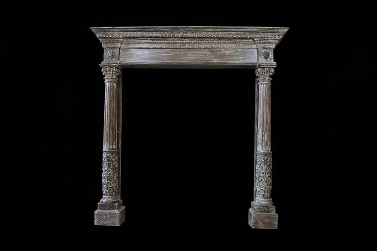 Very important fireplace made out of oak, dating back to the middle of the 19th century, early Napoleon III period. The chimneypiece presents two fluted columns, each of which has a floral decoration at its bottom and a Corinthian capital at its