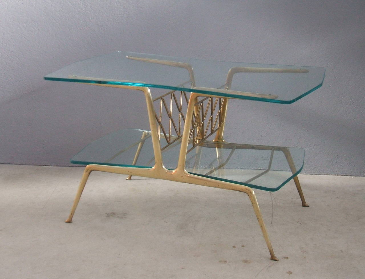 Elegant brass and glass bi-level coffee table with magazine rack.