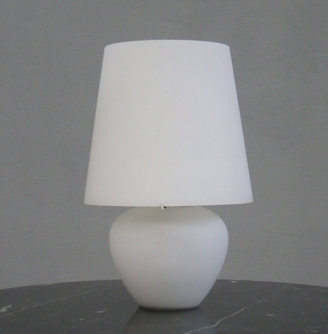 White glass table lamp. Three different light sources: base, shade or both.