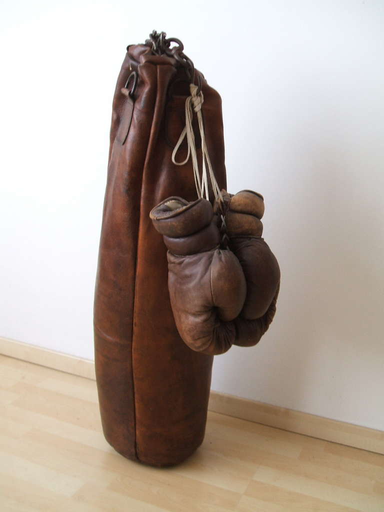 Historic leather punching bag with boxing gloves and original chaine,