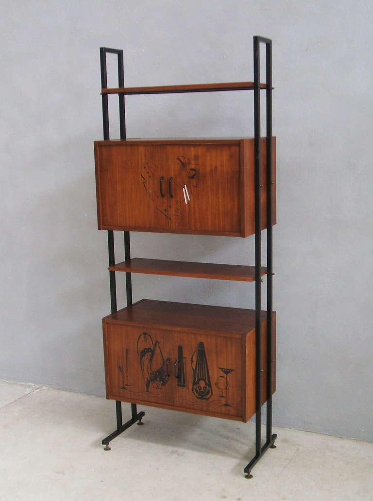 A mid century free standing double bookcase with shelves and two painted cabinet's doors. The depth is respectively 40 cm and 25 cm.