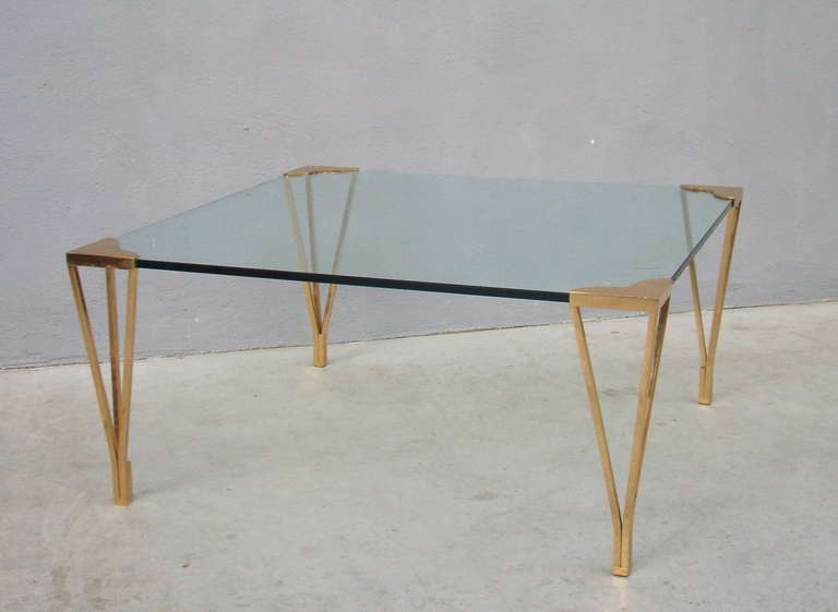 Elegant square coffee table. The brass structure makes 4 hearts in the glass's corner and beautifull legs.