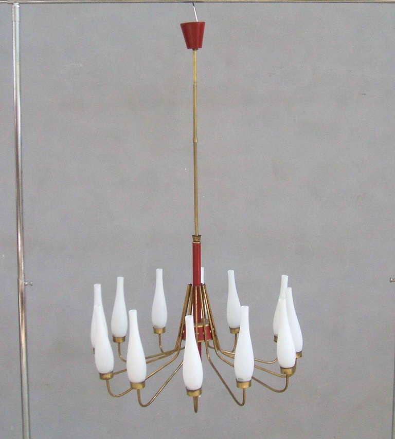 Twelve light red and brass Stilnovo chandelier with fluted shaped opaline glass.