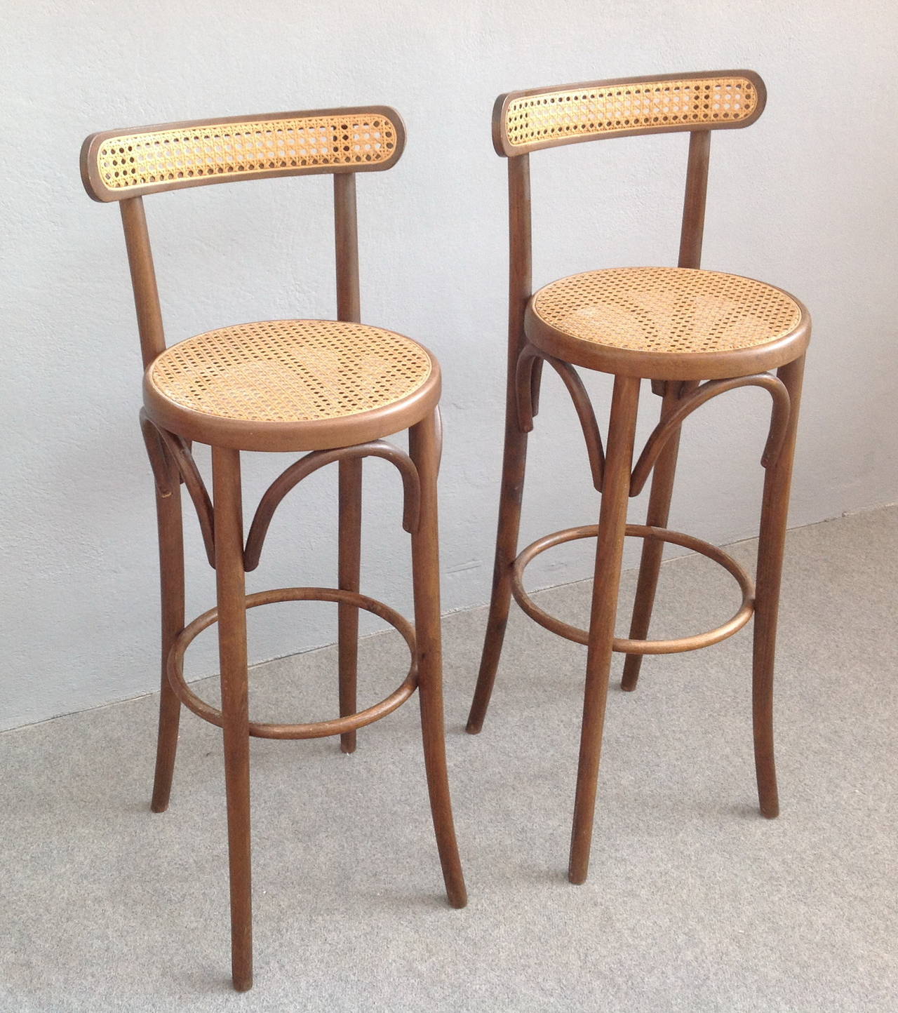 Two Thonet style bar stools. Bentwood and original cane seat and back.