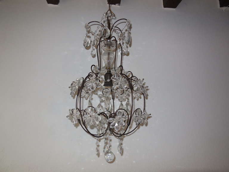 Wonderful rare shape chandelier. Housing 1 light in center under a crystal cup.  Metal scrolled body with perfect patina.  Adorning clear flowers, all in great shape.  Macaroni bead swags, florettes and crystal prisms throughout.    7