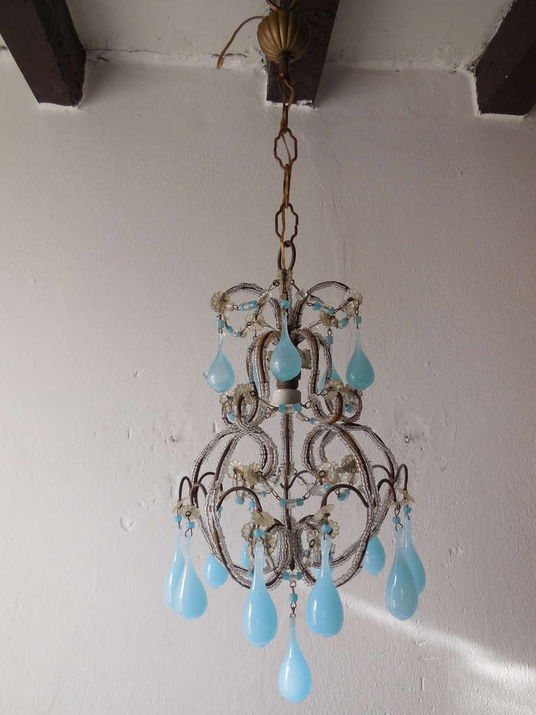 Housing one light.  Big bulbous blue drops with blue beads to match above.  Also adorning swags of macaroni beads with blue beads in center!  Adding  10