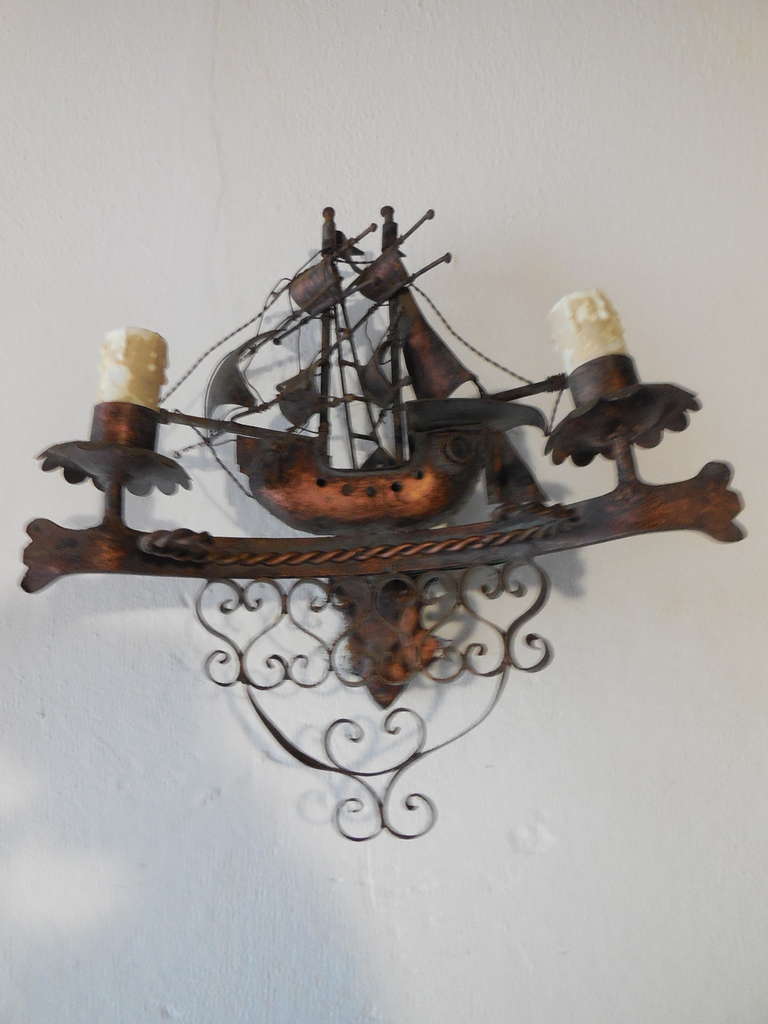 Housing 2 lights each.  Great detailing.  Moveable flags and anchors on these heavy wrought iron sconces.  Re-wired and ready to hang!  Free priority shipping from Italy.