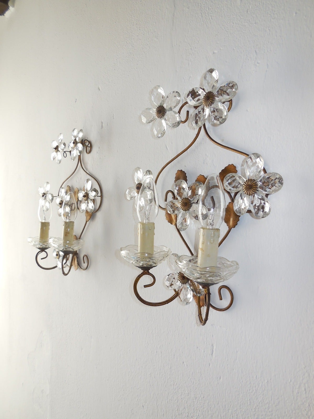 Housing 2 lights each, sitting in crystal bobeches. Gold gilt tole leaves with 6 crystal prism flowers on each. These are made in the Maison Bagues style. Re-wired and ready to hang! Free priority shipping from Italy.