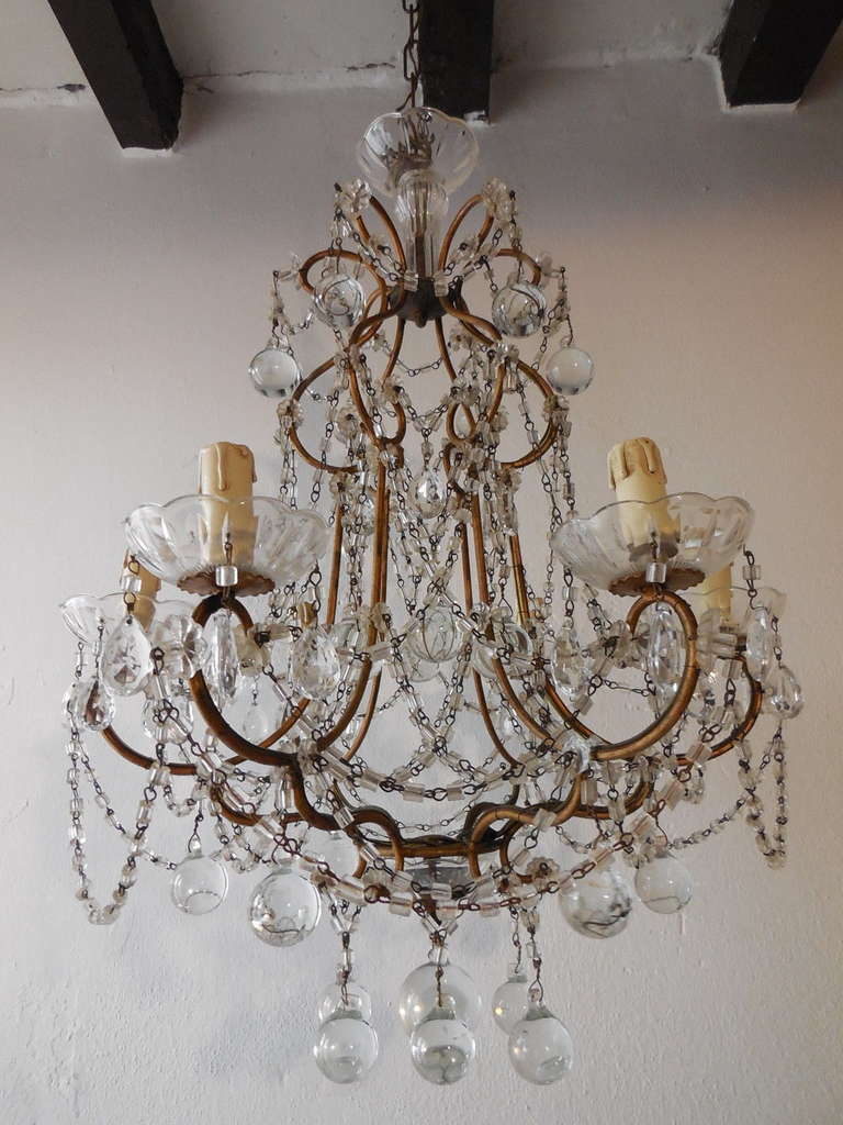 Housing 6 lights.  Will need to be rewired for U.S. standards.  Swags of crystal macaroni beads.  Big fat clear Murano balls. 7 crystal bobeches.