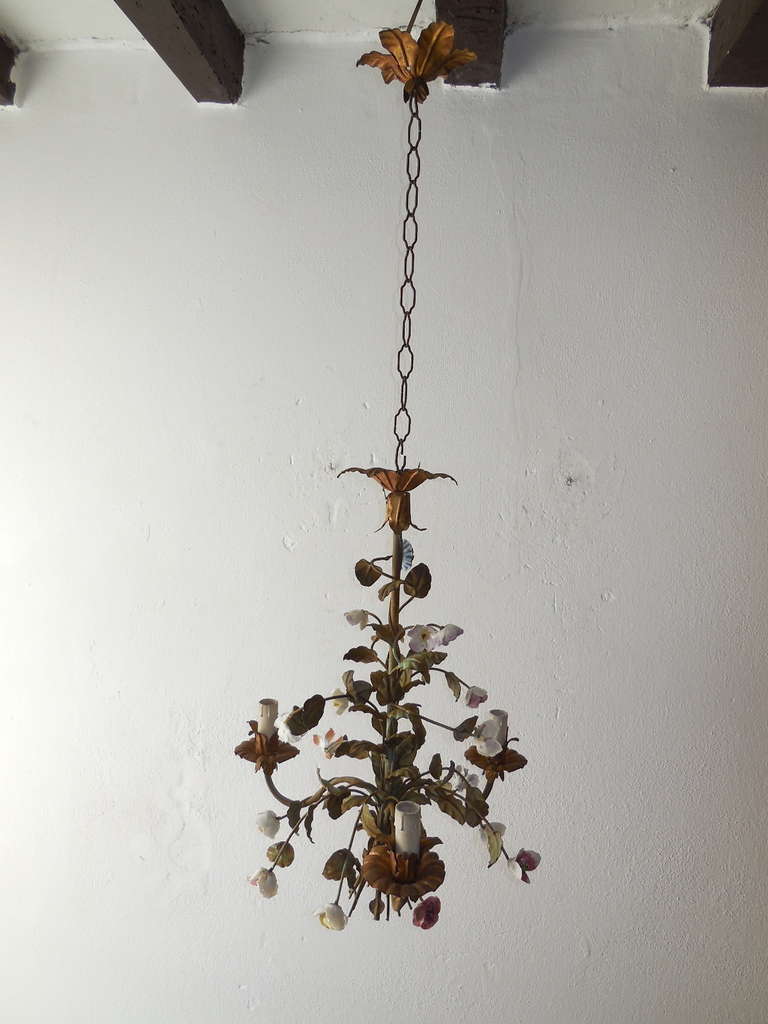 Housing 3 lights.  Bulb holders are in wood.  Tole leaves.  Gold gilded bulb holders.  Handmade porcelain flowers all in great shape.  Adding 19 inches of original chain and canopy.  Found in Northern Italy.  Re-wired and ready to hang!  Free