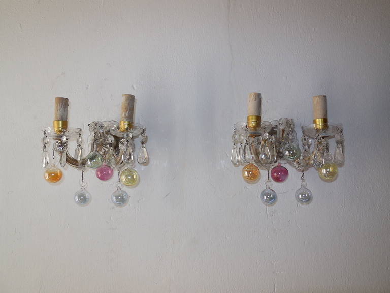 Housing 2 lights each.  Bulb holders are in wood, sitting in crystal bobeches dripping with vintage crystal prisms.  Gold gilt metal arms covered with clear Murano glass.  Each adorning 6 extremely rare Murano blown glass balls in yellow, orange,