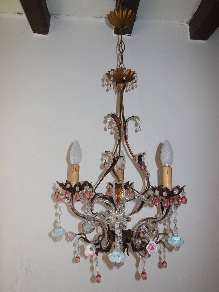 Housing three lights. Tole body with beaded leaves and bottom. Adorning rare pink drops and beads on top throughout. Also, porcelain flowers and Murano clear balls encircled with a blue ribbon dripping from crystal prism flowers. Also canopy has