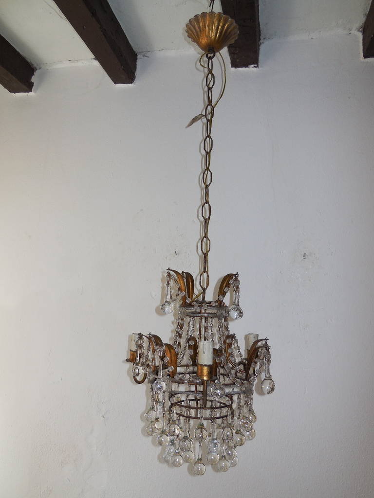 Housing three lights, bulb holders in wood. Gold gilt tole metal. Macaroni beaded swags with tiny beading and florets on top and center.  Clear Murano drops, all intact.  Adding 19