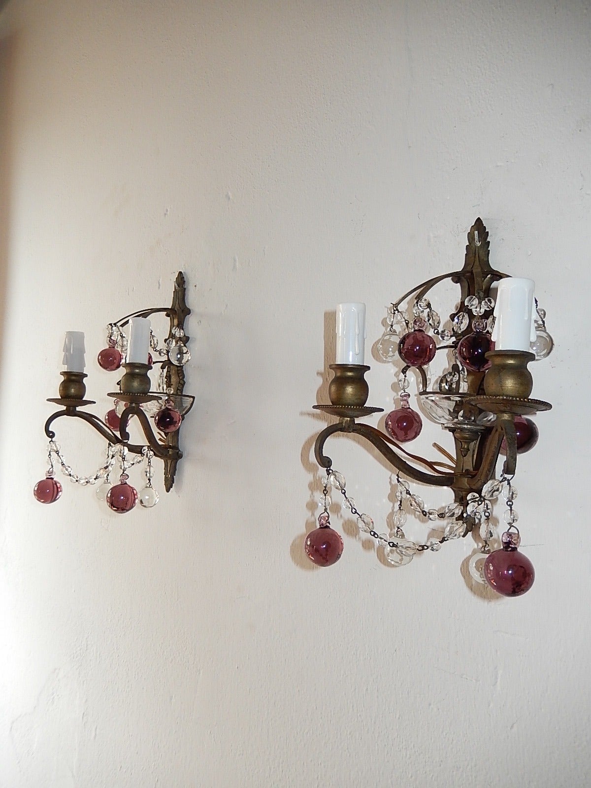Housing two lights each.  Adorning Murano glass balls in clear and amethyst.  Bronze body with perfect patina.  Swags of crystals.  Free priority shipping from Italy.  Re-wired and ready to hang.