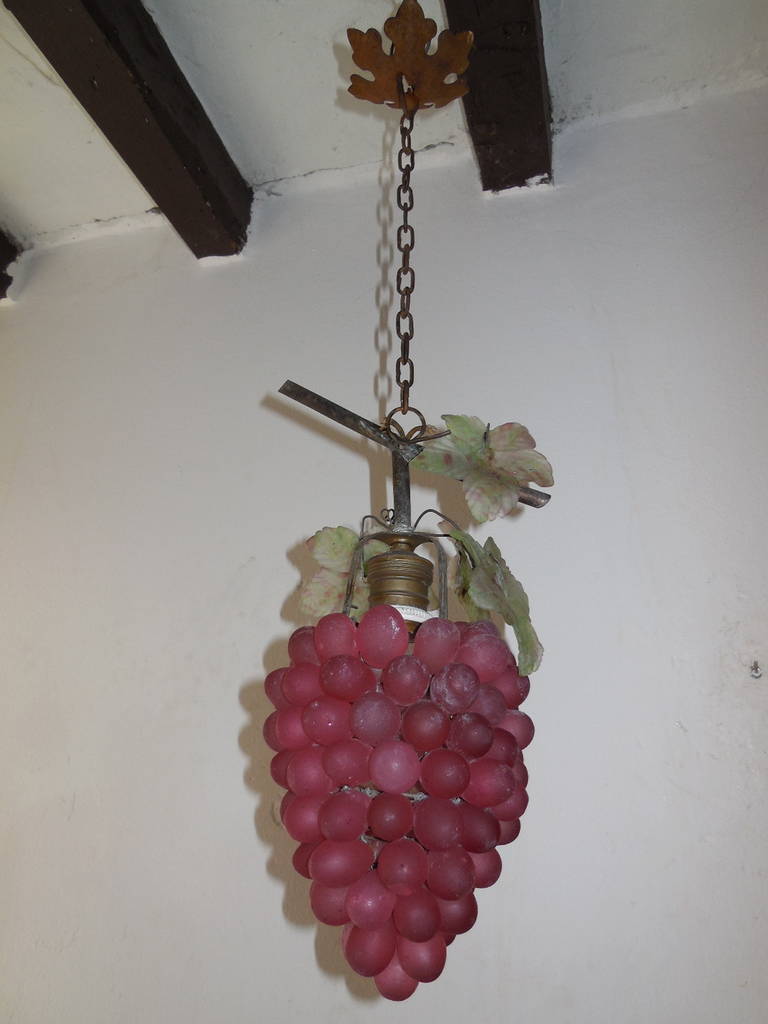 Housing one light. Glass grapes in a bordeaux color. Wonderful big glass leaves on top as well. Metal top resembling the cluster branch.  Adding another 9 inches to the length of chain and canopy. Re-wired and ready to hang!  Free priority shipping