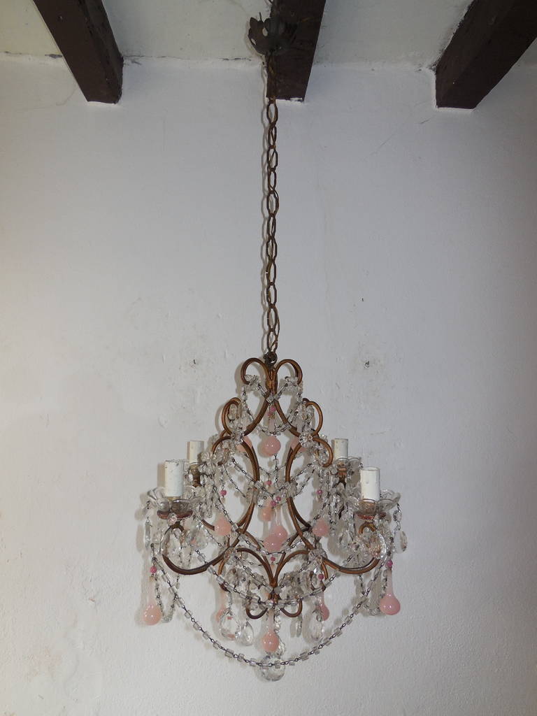 1920 Housing 4 lights, bulb holders sitting in crystal bobeches, dripping with vintage crystal prisms.  Swags throughout.  Rare bubble gum pink opaline Murano drops with hot pink opaline beads on top.  Adding another 21 inches of original chain and