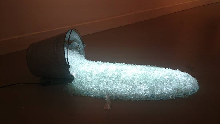 " Light Spill" created in 2012 and part of the " Digging Light" Series.
This light sculpture is made up of shards of glass which are lit by led light and spill out of a bucket. Albert Geertjes is an independent artist and