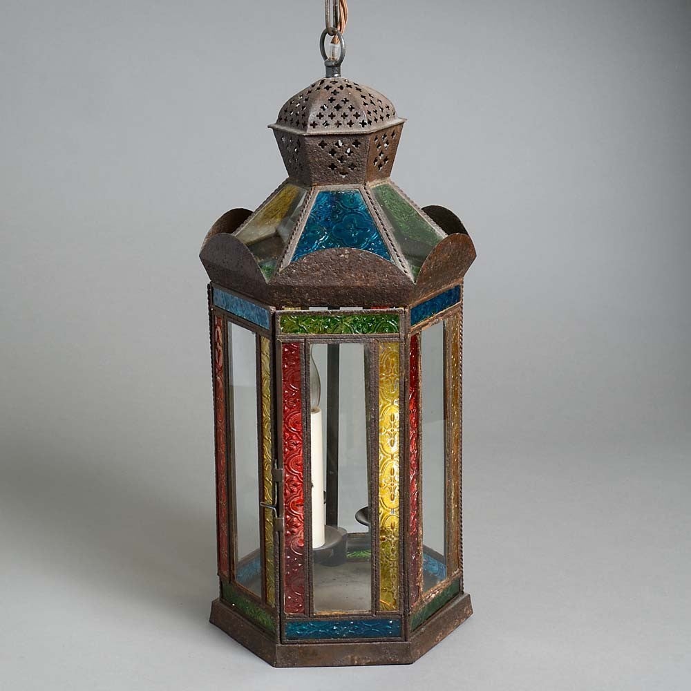 A charming early 20th century hall lantern in the Moorish taste, the tole body set with etched coloured glass panels. Now wired for electric lighting.