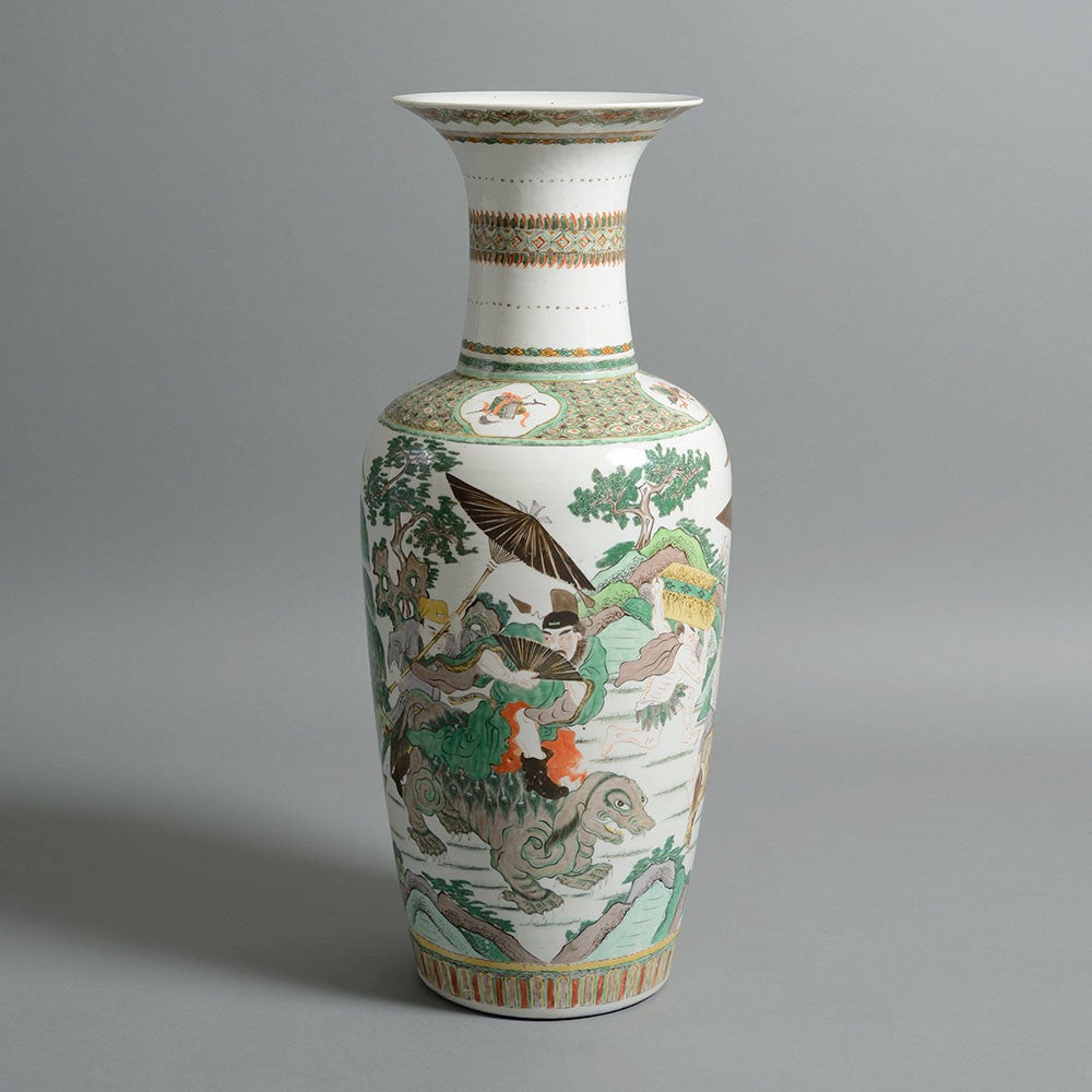 A 19th century famille verte vase of great scale, the body decorated with floral and figurative scenes on a baluster body with trumpet stem. 

The famille verte colour palette was adopted in the Kangxi Period (1662–1722) and specifically uses