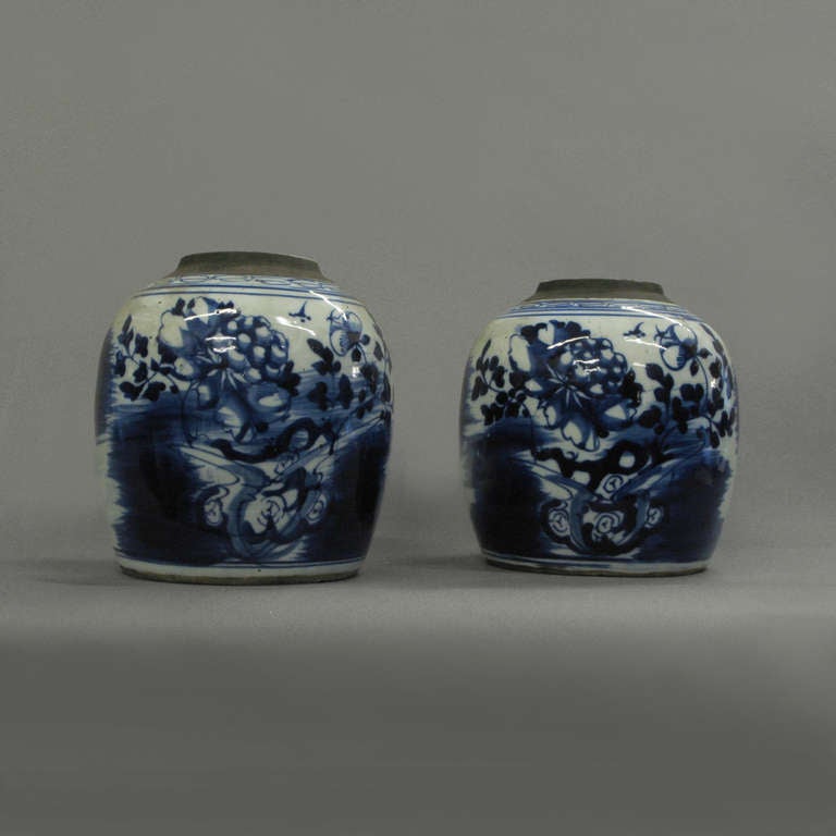 A pair of nineteenth century ginger jars of bulbous form, decorated with stylised flora and fauna