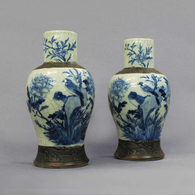 A pair of large scale crackleware vases, the bodies with blue and white glazes and having matt brown collars and bases