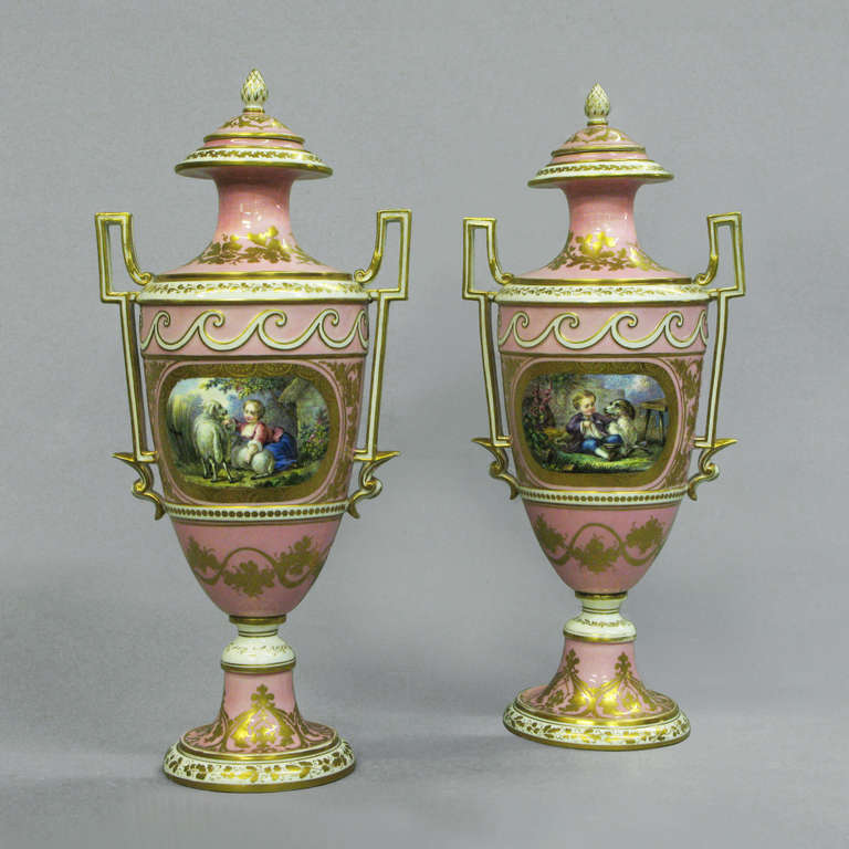 A Pair of Sevres Pink Ground Vases & Covers