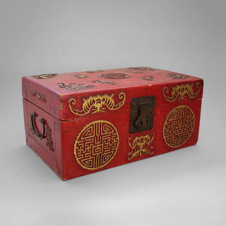 A red lacquer and gilt casket with lock escutcheon and carrying handles