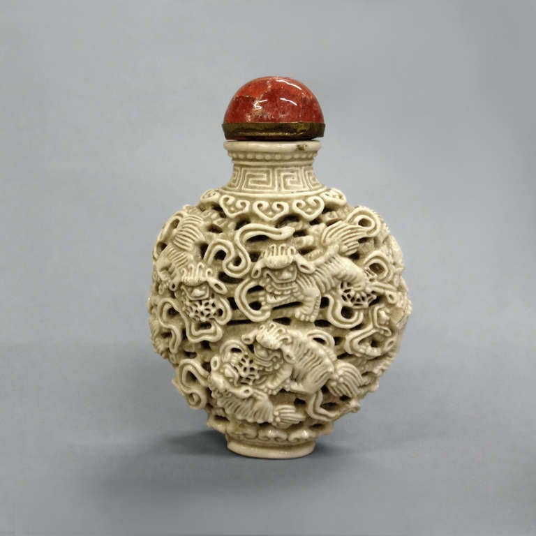 A carved porcelain snuff bottle chin