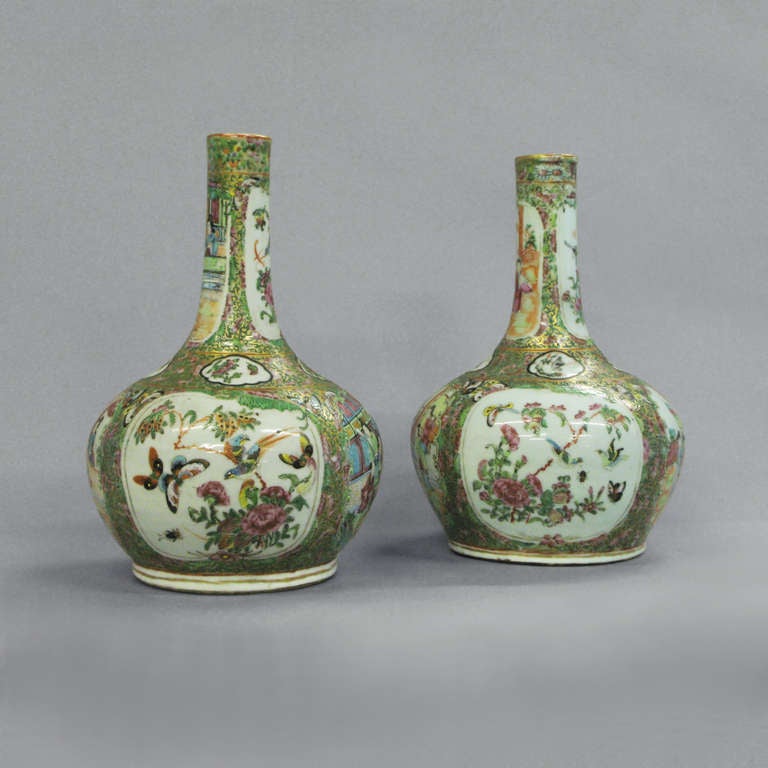 A pair of nineteenth century Canton bottle vases, decorated throughout with birds, butterflies and flowers