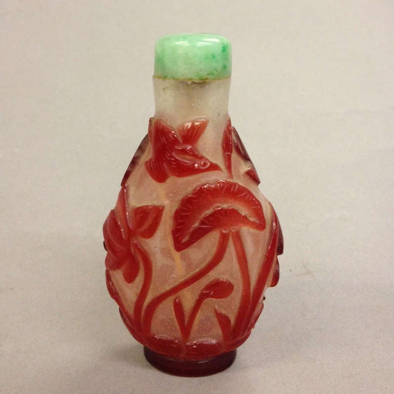A snuff bottle with overlay decoration