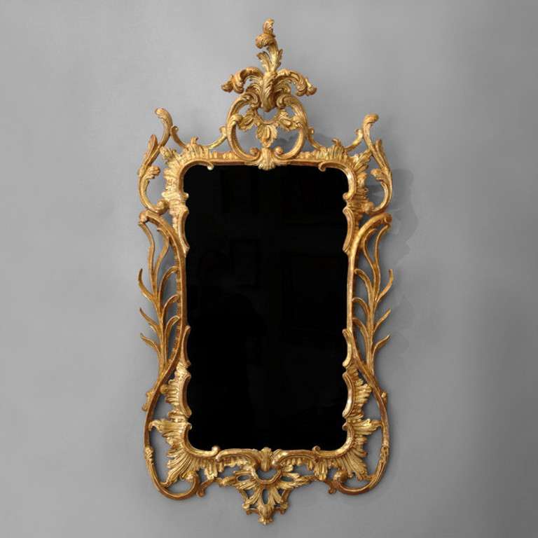 A Mid-18th century carved giltwood mirror in the rococo taste.

The rococo movement affected all the arts in the second quarter of the eighteenth century including painting, sculpture, architecture, interior design, literature, music, and theatre.