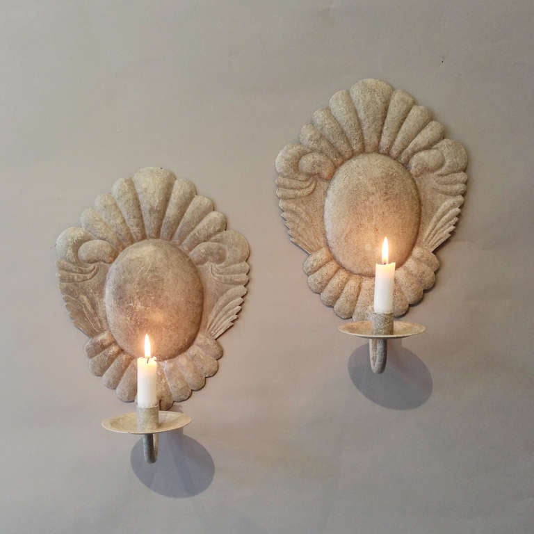 A pair of tole single arm wall lights in the Louis XV manner, the cartouche backs with a single candle arm.