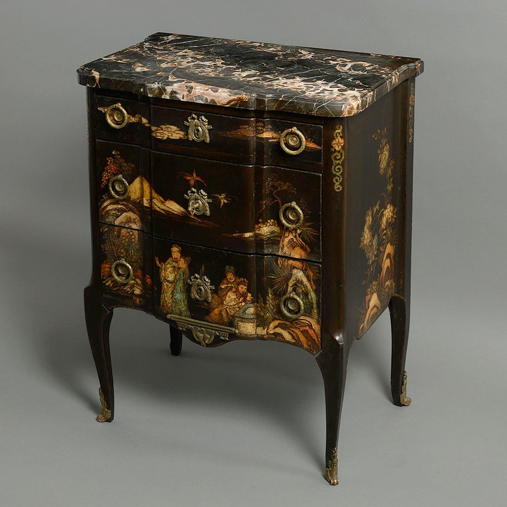 A late nineteenth century Coromandel lacquer three drawer commode in the transitional manner, the finely veined original black marble top above three shaped long drawers, all set upon tall cabriole legs with brass capped feet. 

This chest follows
