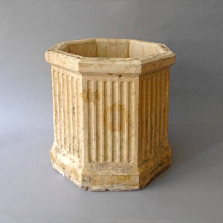 An early 20th Century terracotta planter in the Louis XVI manner, of hexagonal form having fluted sides.