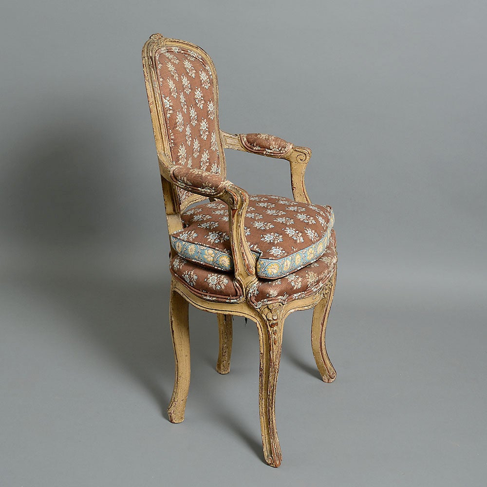 A rare pair of mid-18th century painted miniature fauteuil, both with upholstered cartouche backs, scrolling arms and over-stuffed seats and raised on cabriole legs.

These chairs were most probably made as apprentice pieces, or examples of