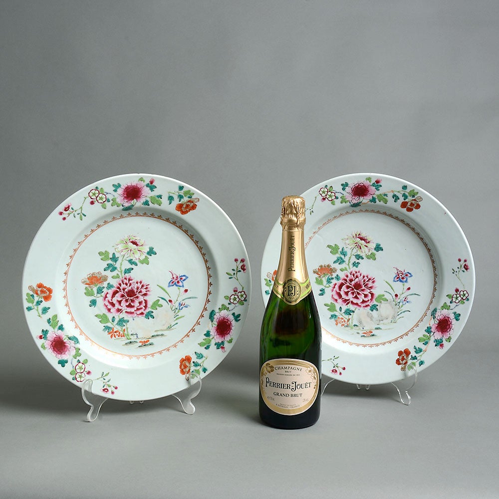 A fine late 18th century pair of famille rose porcelain chargers, with floral decoration in polychrome glazes upon a white ground. 

Qianlong Period (1735 - 1796) 

Both plates with minor rim frits