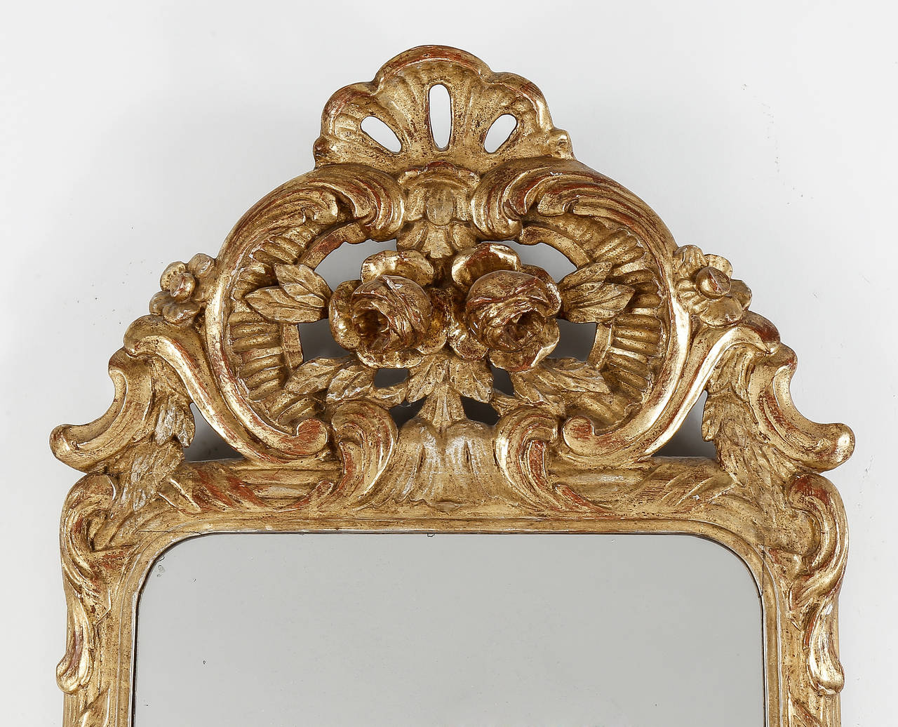 A fine Gustavian Period giltwood pier mirror, the cresting and apron with elaborate carving, having two mirror plates in the traditional manner.