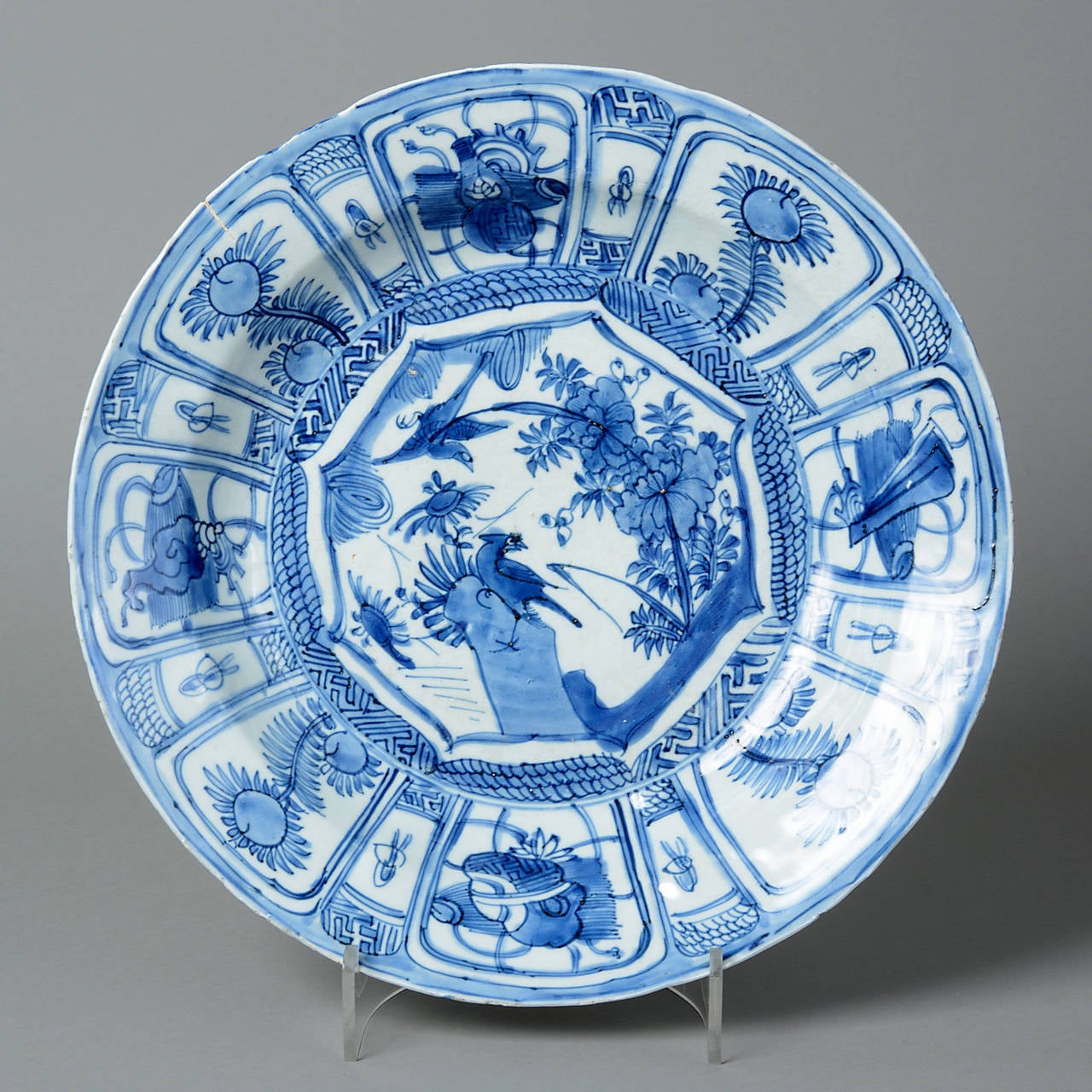 An early 17th century blue and white porcelain Kraakware charger.

Using a technique perfected during the Ming dynasty, Kraak porcelain was often painted using a glazed cobalt blue. Underglazing is a method of applying the pigment to the ceramic