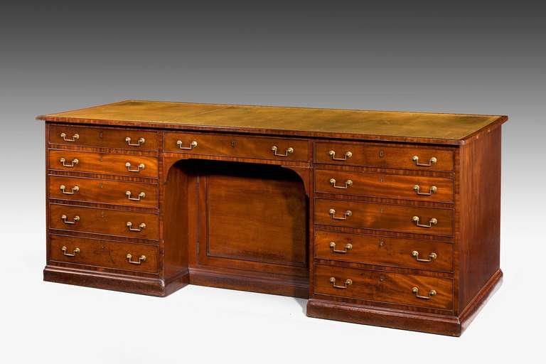 Chippendale period library desk, with 11 drawers to each side, the top, top edge and all the stiles cross banded in highly figured mahogany, period square section drop handles.

