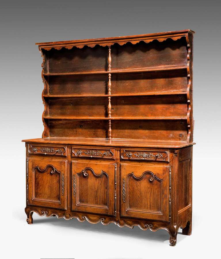 A French 18th century chestnut dresser, original plate rack to the top section, very good steel mounts and handles original and in wonderful overall condition, mid-18th century. 

Provenance: A Welsh dresser sometimes known as a kitchen dresser or