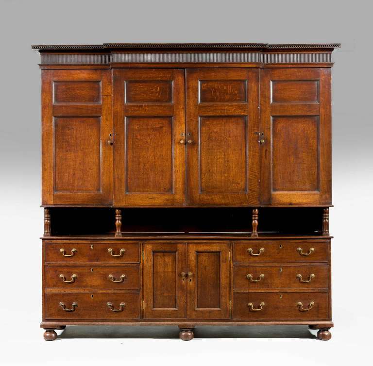 A Good George III period Oak Housekeeper’s Cupboard of quite sophisticated design, the top with a well carved incised border, the upper section support on turned pillars. Excellent overall condition. 

Provenance: A Welsh Dresser sometimes known