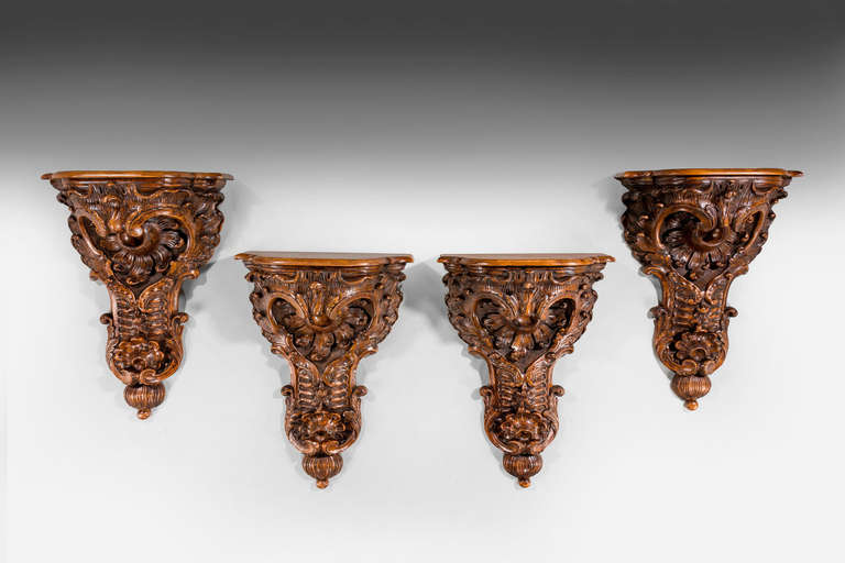A rare set of four massive 19th century walnut Brackets, vigorous carving with foliage, shells and flowers, almost certainly Italian.