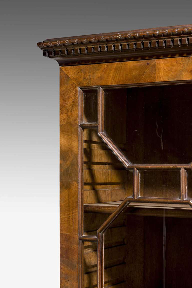 Exceptionally fine early George III mahogany bookcase. This china display-case is in the tradition of a group of elaborate cabinets of circa 1765, all of upright form and, as with this cabinet, incorporating a chest of drawers on tall square legs,