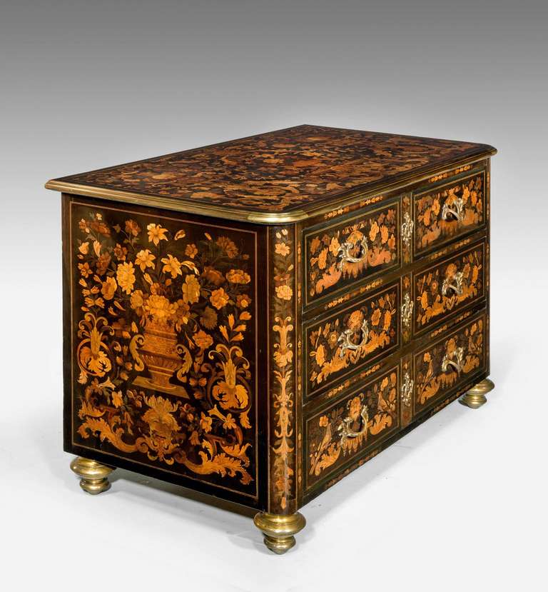 An exceptionally fine and rare early 19th century commode. The marquetry inlays of the finest quality and with more than a dozen contrasting timbers.